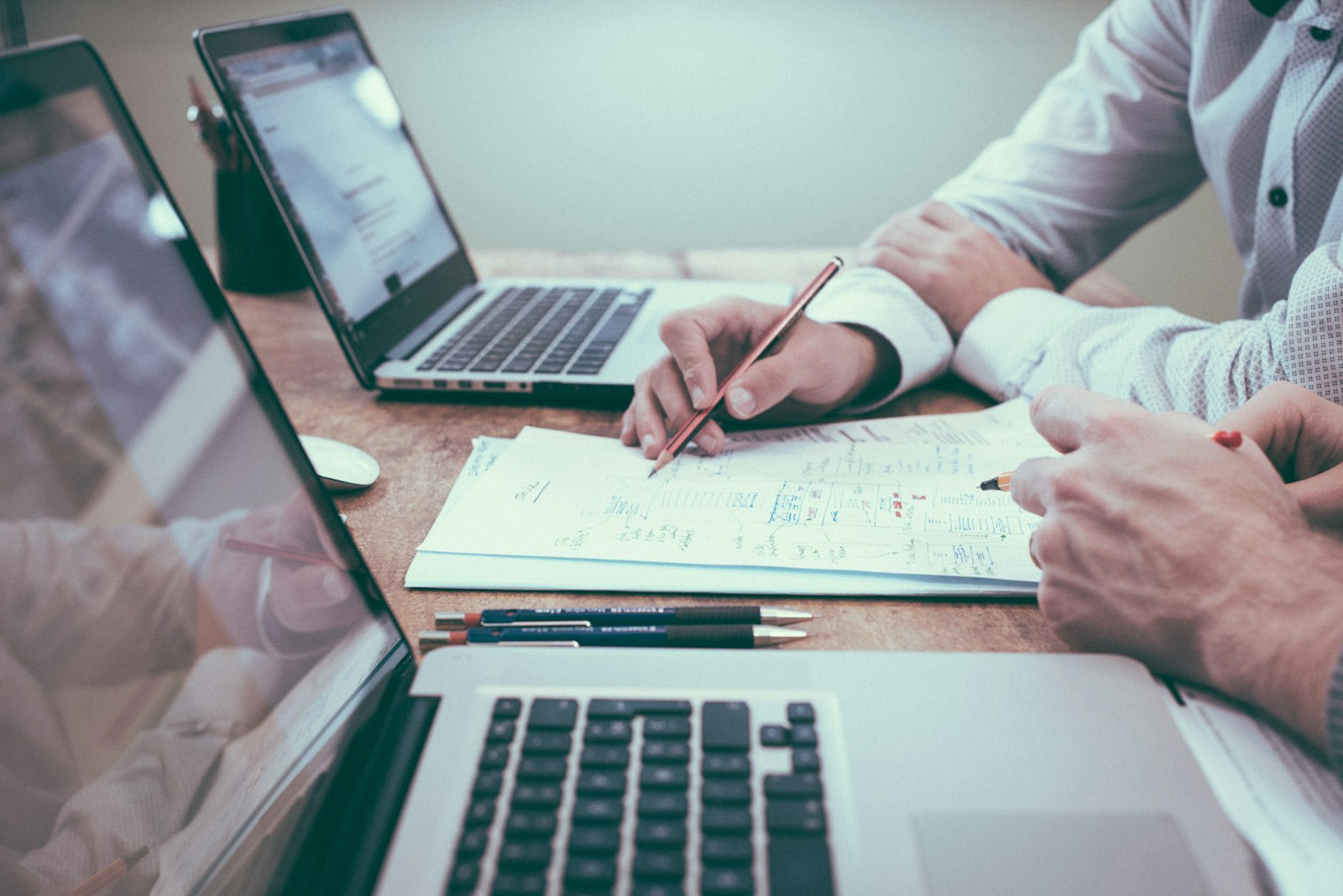 Accounting professionals reviewing financial reporting materials